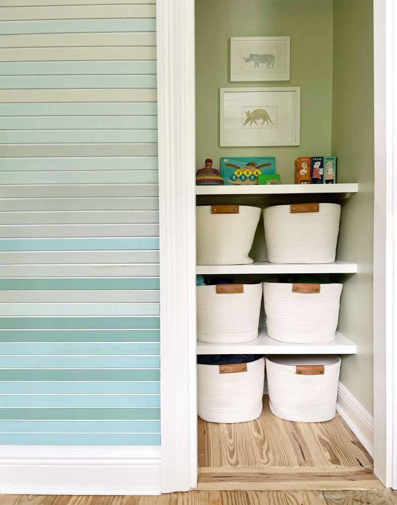 Painted Closet With Custom DIY Shelves And Art Hanging Above Them