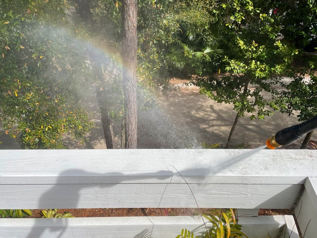 Rainbow created by overspray during pressure washing railings on deck