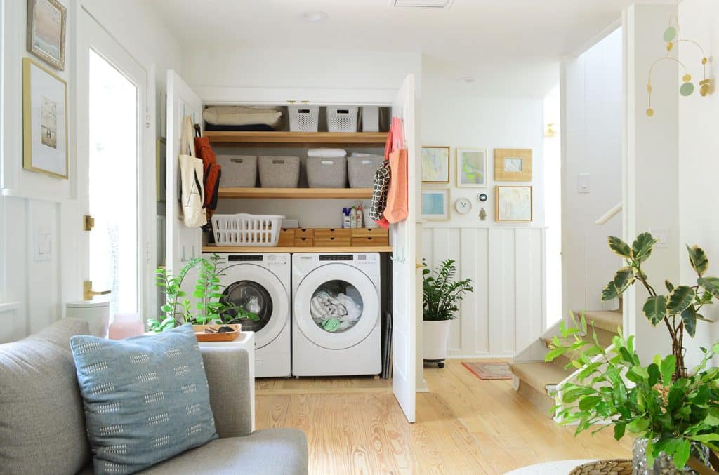 View Of Open Laundry Closet Behind Seating Area In Kitchen