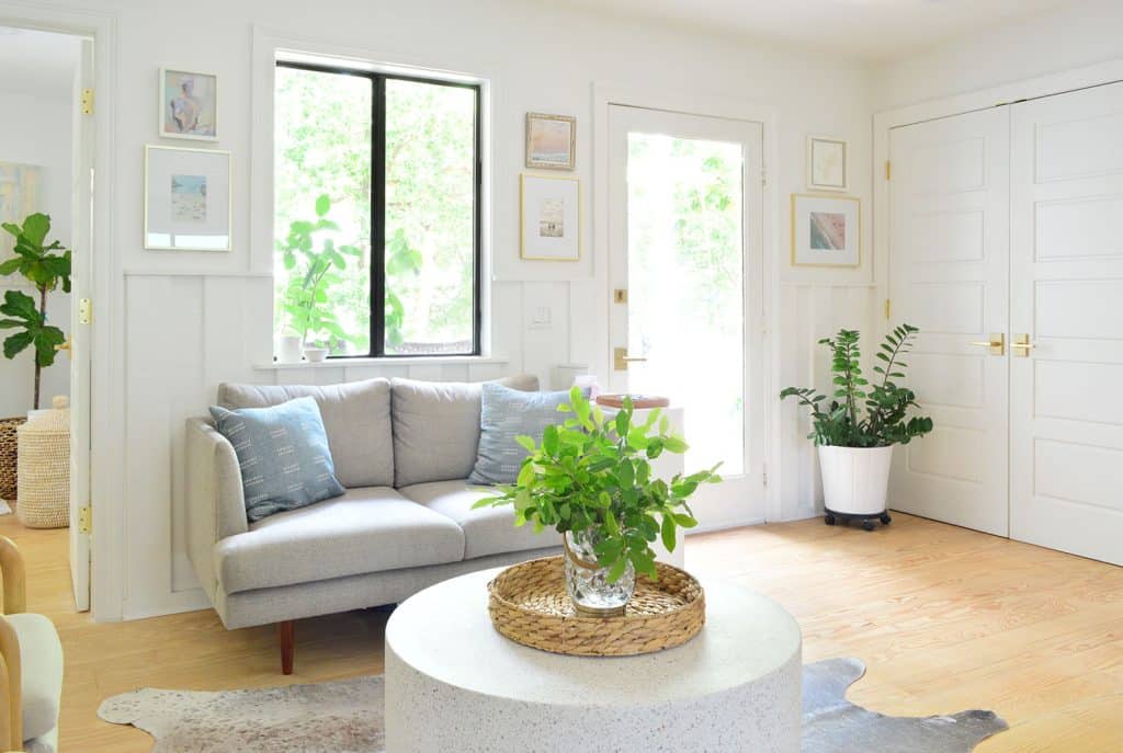 View Of Seating Area And Front Door With Laundry Closet In Background