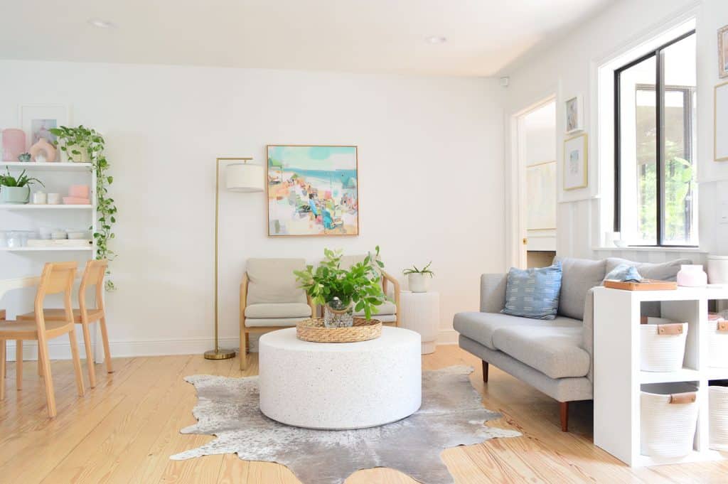 Seating Area With Round Stone Coffee Table Next To Kitchen