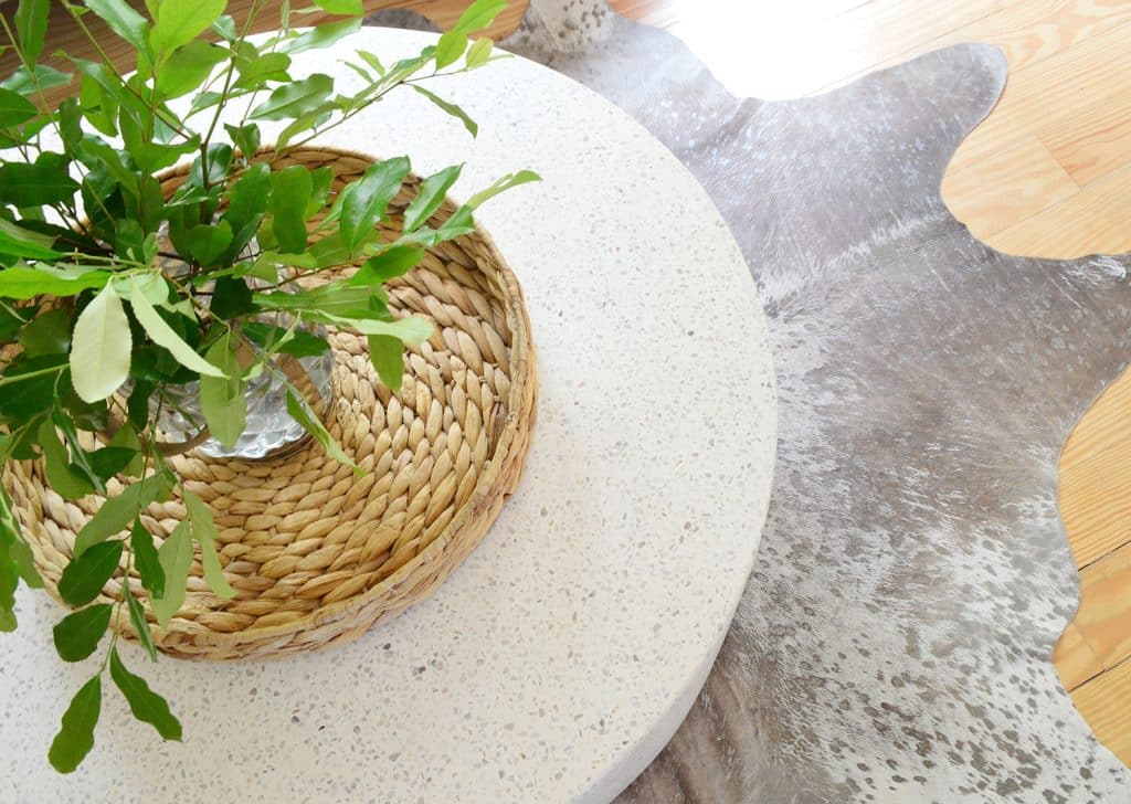 Overhead View Of CB2 Terrazzo Outdoor Coffee Table On Metallic Cowhide Rug