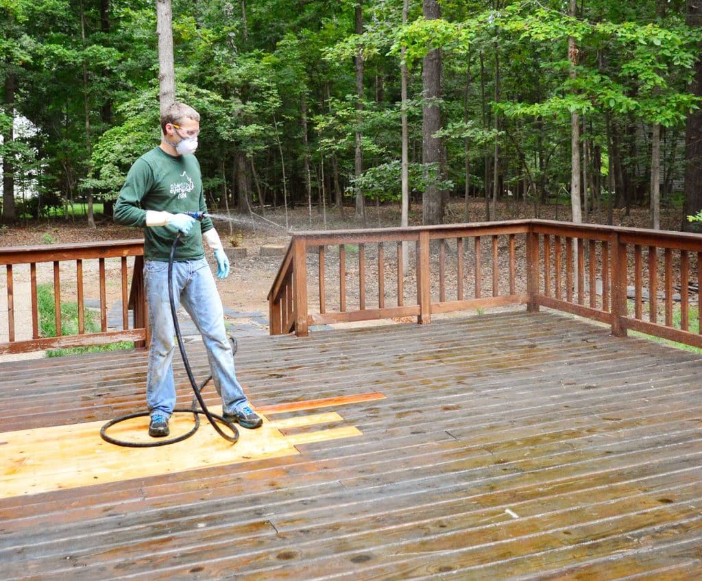 John misting wood deck to keep chemical stripper wet