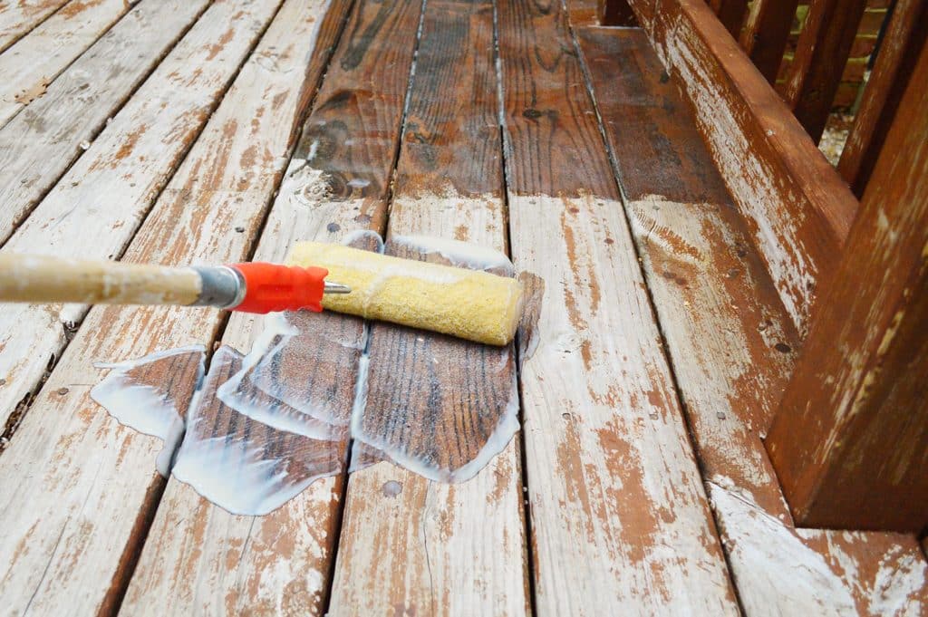 Rolling deck finish stripper onto wood deck