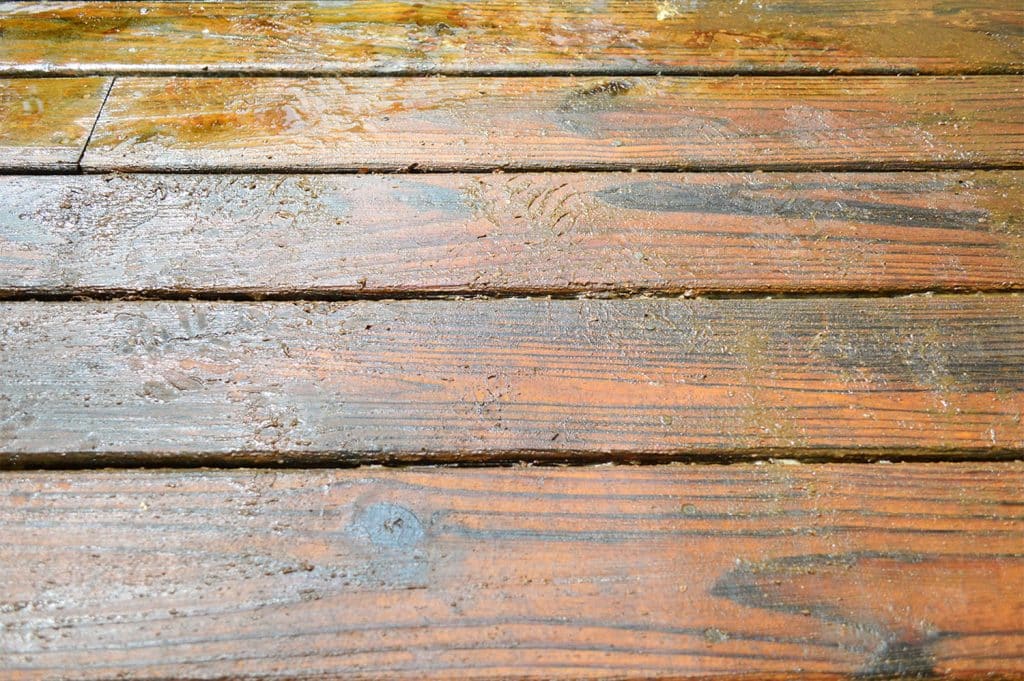 Detail of deck finish stripper peeling old stain finish off wood deck