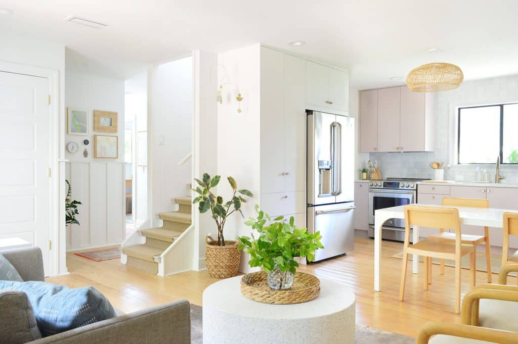 Wide View Of Beachy Mauve Kitchen and Seating Area With Stairs