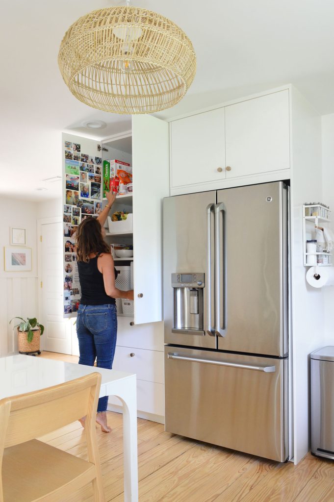 Sherry Standing In Front Of Open Ikea Pantry Cabinets Built To Ceiling