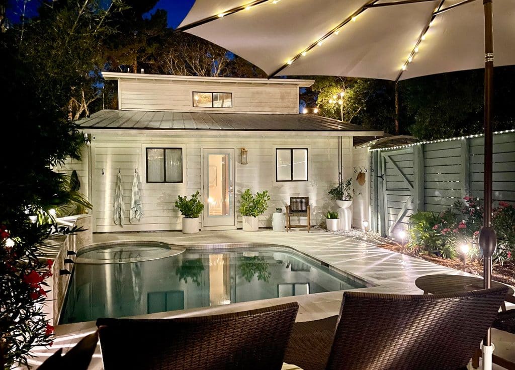 Nighttime View Of Back of House With Pool And Solar LED Lighting