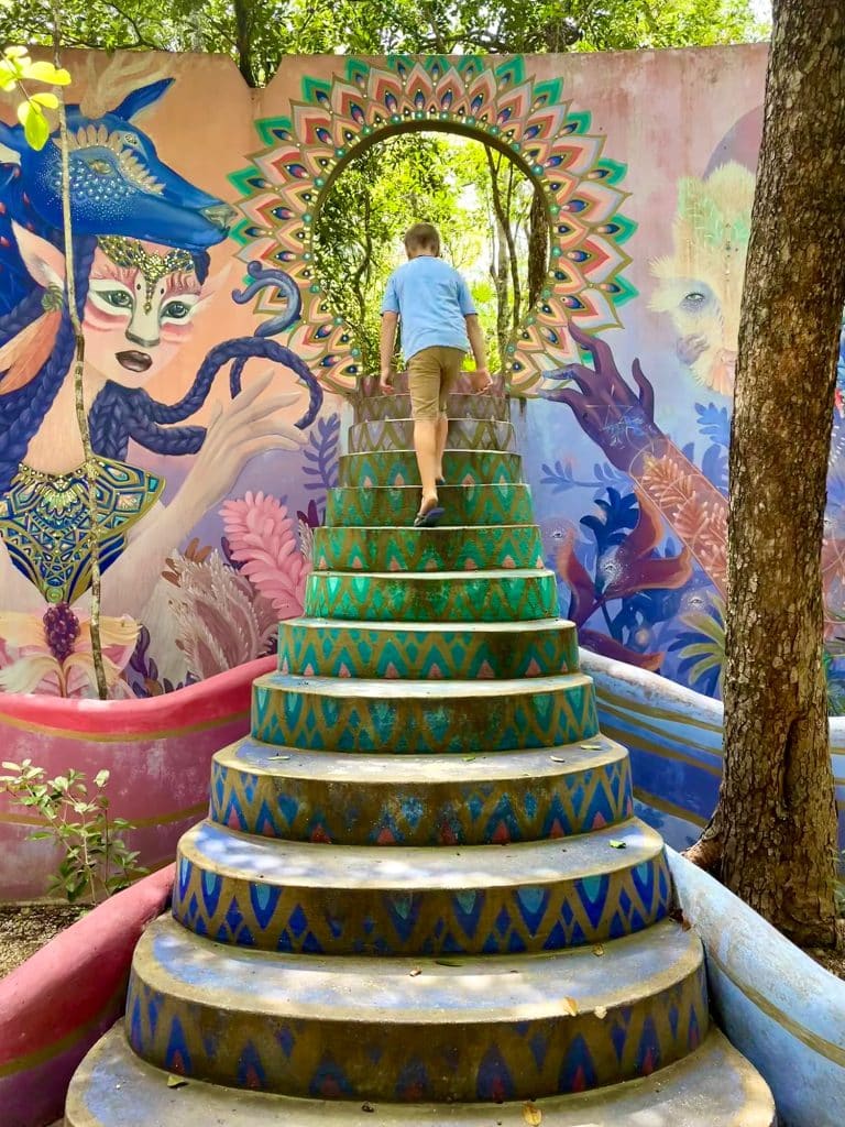 Boy Walking Up Steps Of Holistika Mural Art Walk