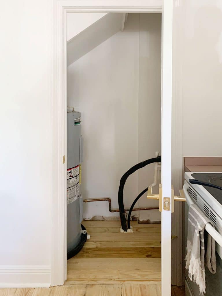 Before Photo Of Utility Closet With Large Water Heater Tank