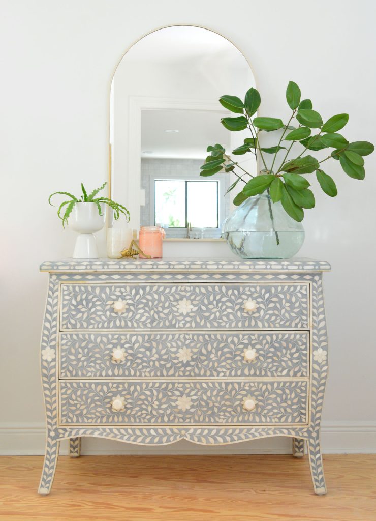 Blue and white inlay dresser with arch brass mirror and large plant vase