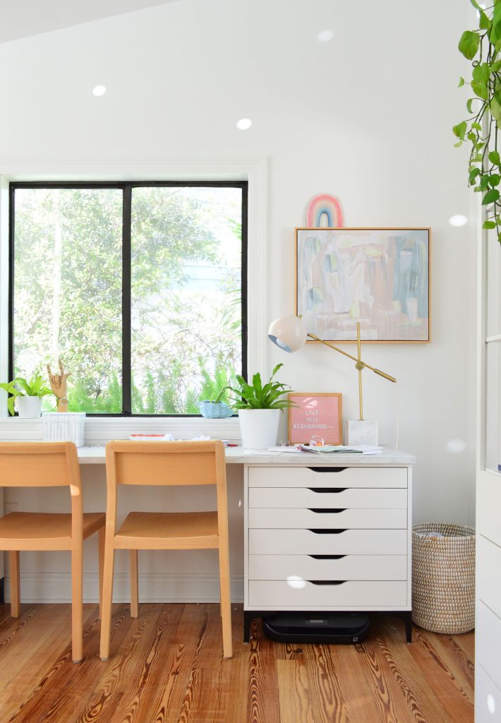 Kids art desk made from Ikea dressers and laminate marble countertop with wood chairs