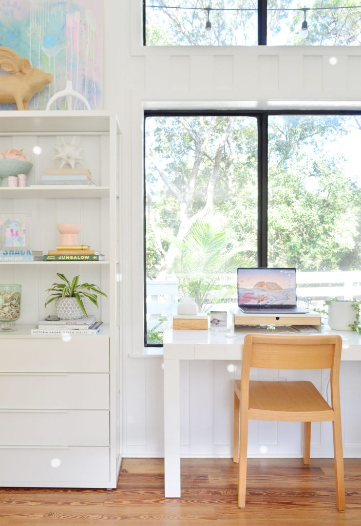 West Elm Parsons Desk in large picture window with Ikea Fjalkinge shelves