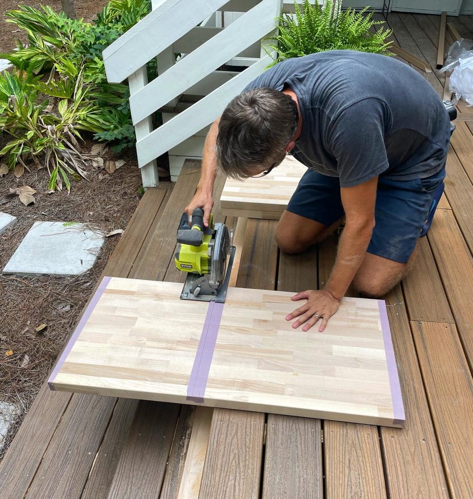 John Cutting Butcher Block Using Circular Saw On Porch