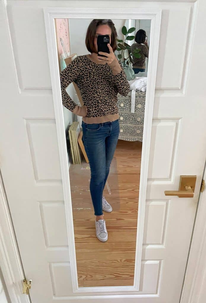 Sherry selfie in mirror at home with leopard sweater and jeans