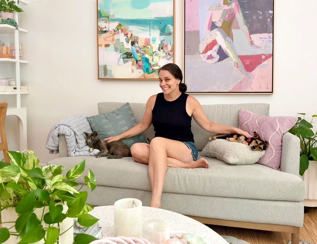 Sherry Sitting On Couch With Cat and Dog On Either Side