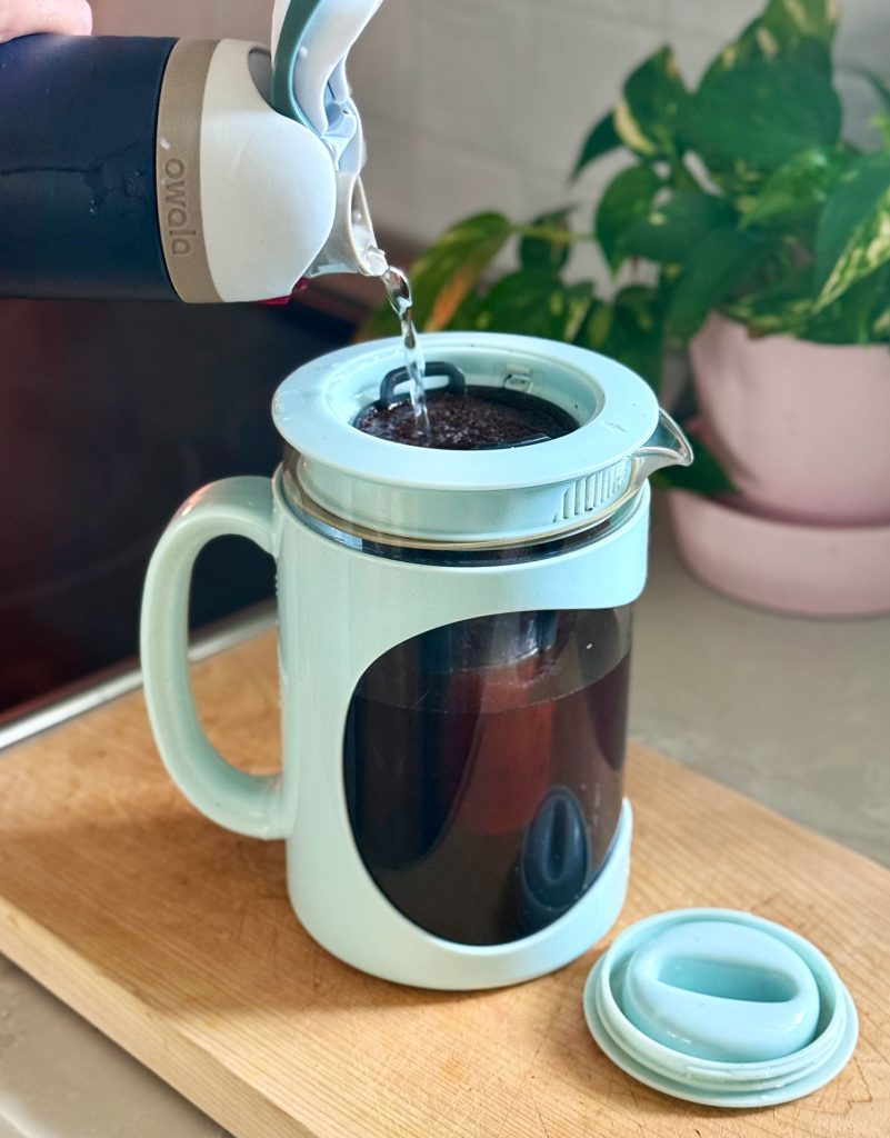 Adding Water Over Coffee Grounds In Home Cold Brew Maker