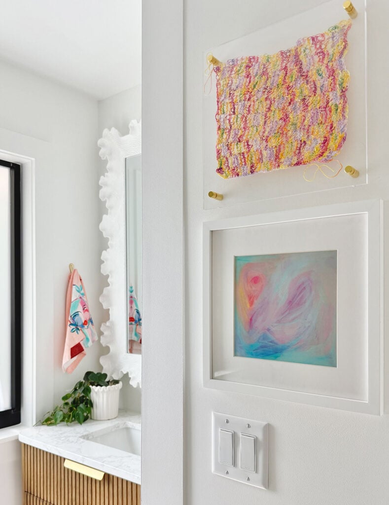 Colorful Artwork on Walls Of White Bathroom