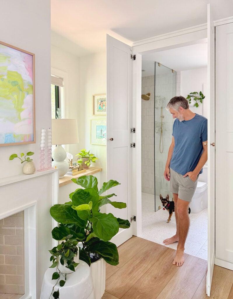 John Standing In Doorway Of New Bathroom With Penny In Background