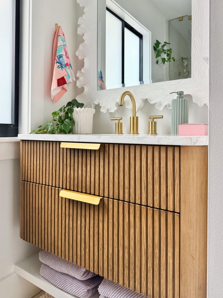 Close Up Of Fluted Wood Floating Vanity With Brass Accents
