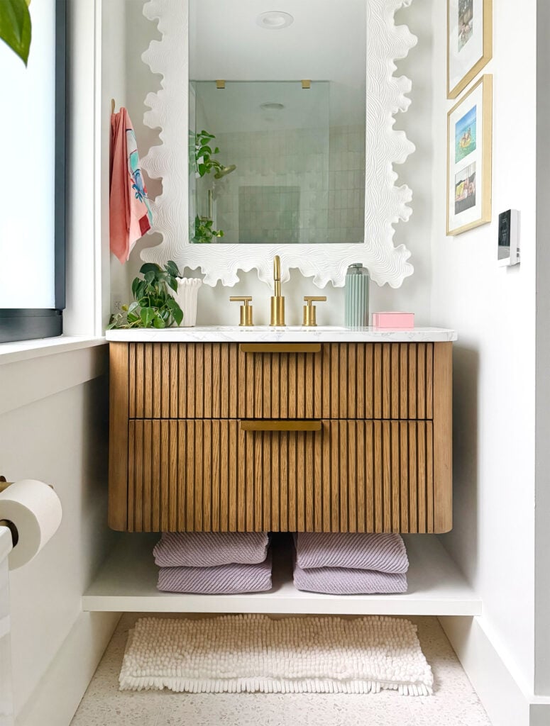 Wood Floating Vanity In White Bathroom With Brass Hardware