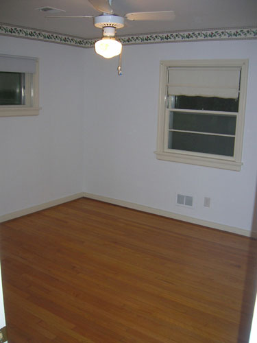 Dated Bedroom With Wallpaper Border And Cream Trim