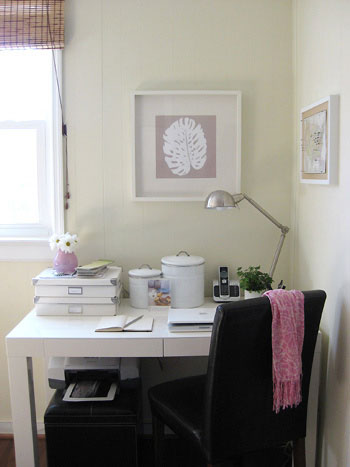 Small corner office with West Elm parsons desk with palm leaf artwork