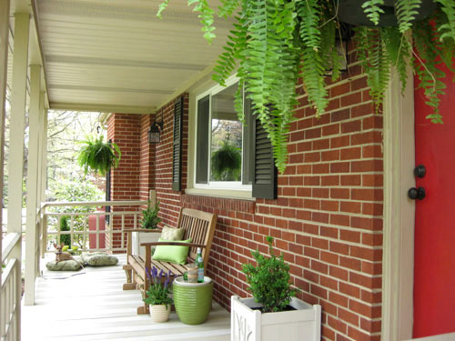 Brick Ranch Front Porch With Red Door and Ferns