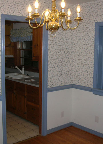 Dated Dining Room With Blue Trim And Wallpaper